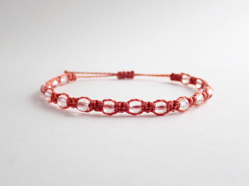 aries bracelet. star sign bracelet. zodiac bracelet. macrame bracelet in earth red coloured string. knotted with 4mm clear quartz. adjustable in size.